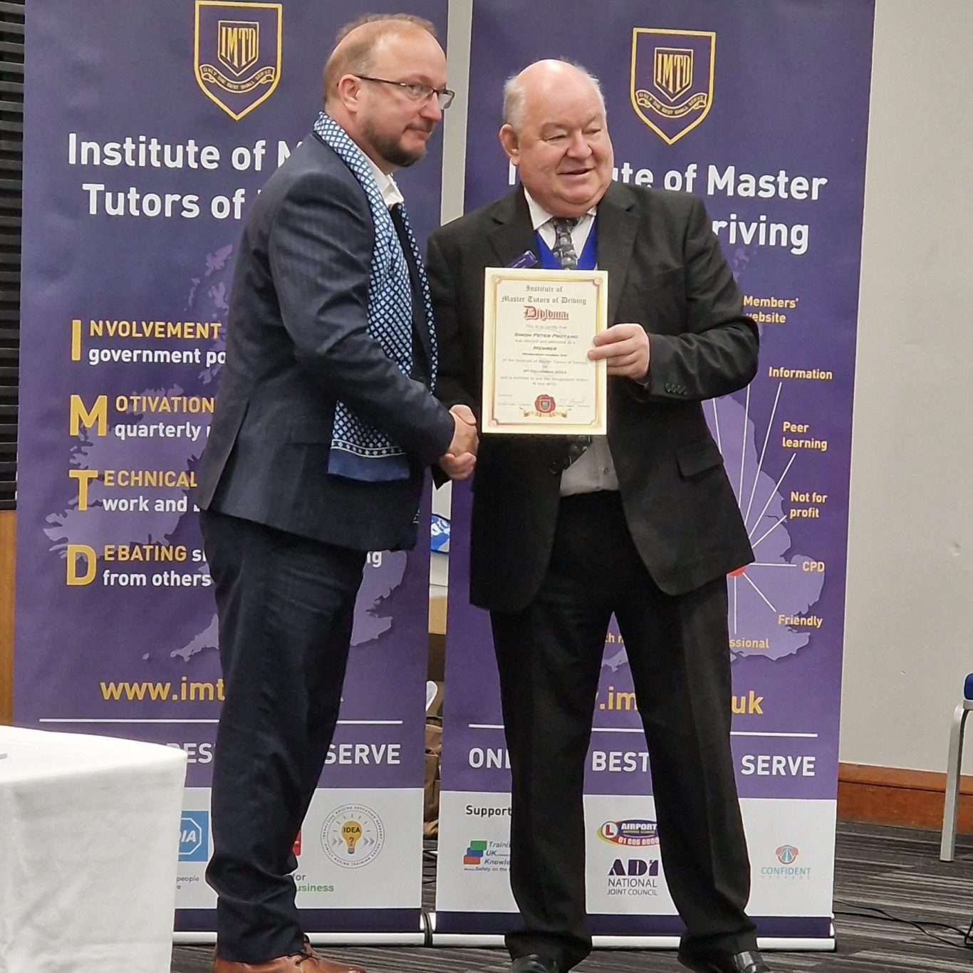 Simon Protano (on the left) becoming a member of The Institute of Master Tutors of Driving